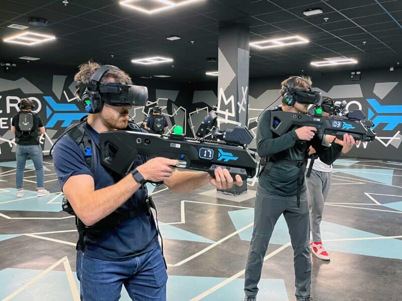 Christmas party venues: a group playing together in a free roam VR arena
