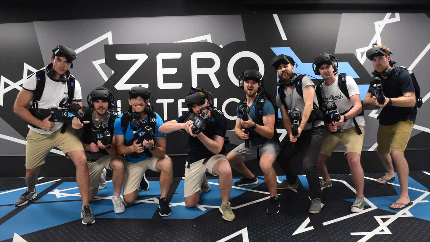Team posing after a free roam VR session, one of the best work Christmas party ideas